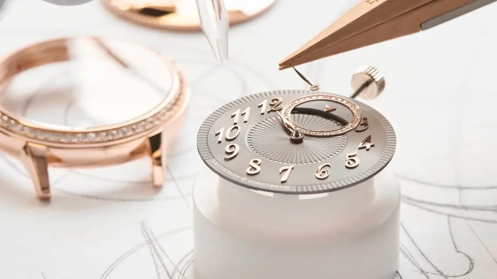 Watchmaker assembling a Vacheron Constantin dial with rose-gold case and diamond-set details